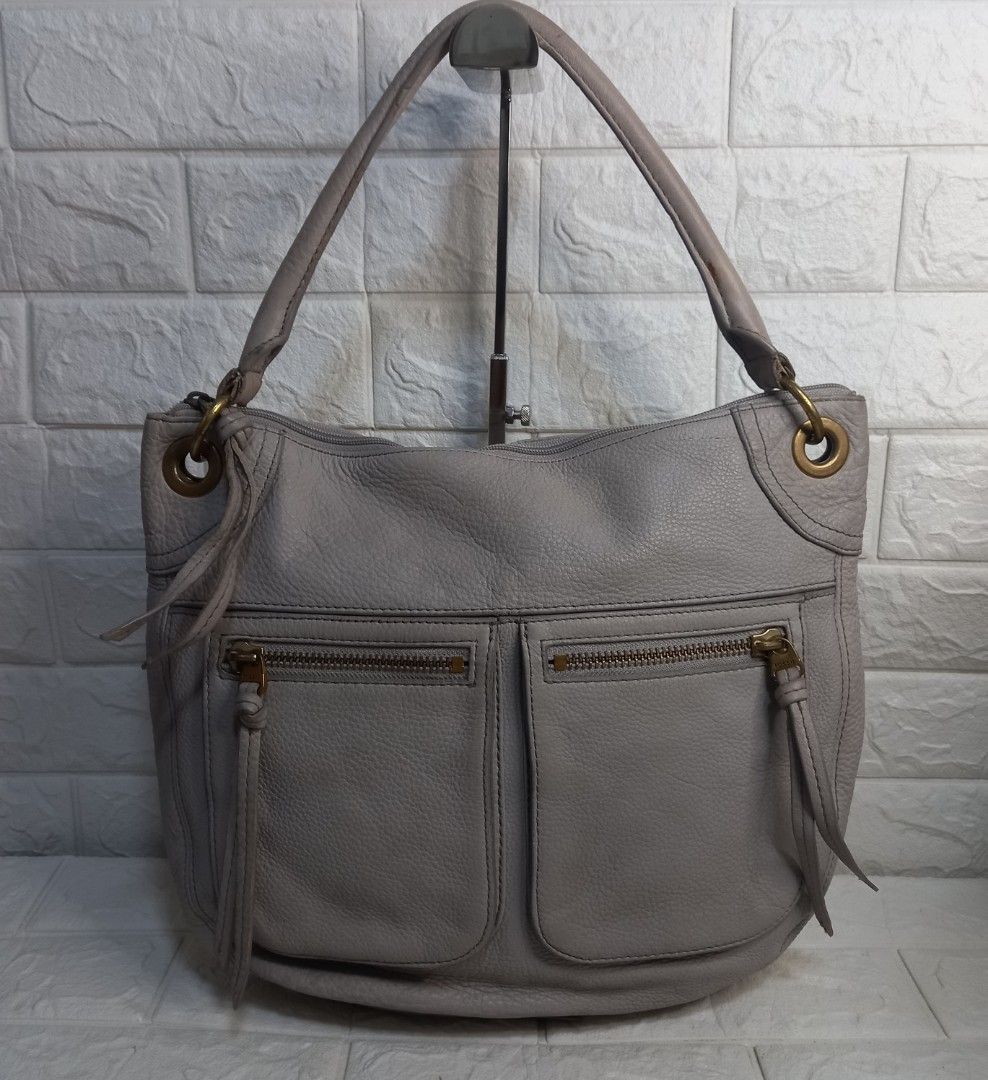Fossil Karla Grey Leather Hobo Bag (Category: Shoulder Bags) located in Las Pinas. Submitted by etoksi1234 (Listing ID 1438757094, Image 1). Description: Pre-loved Fossil Karla Grey leather hobo bag with gold hardware. Features two front zip pockets and a single shoulder strap. Versatile, neutral color. With flaws on rubber lining..