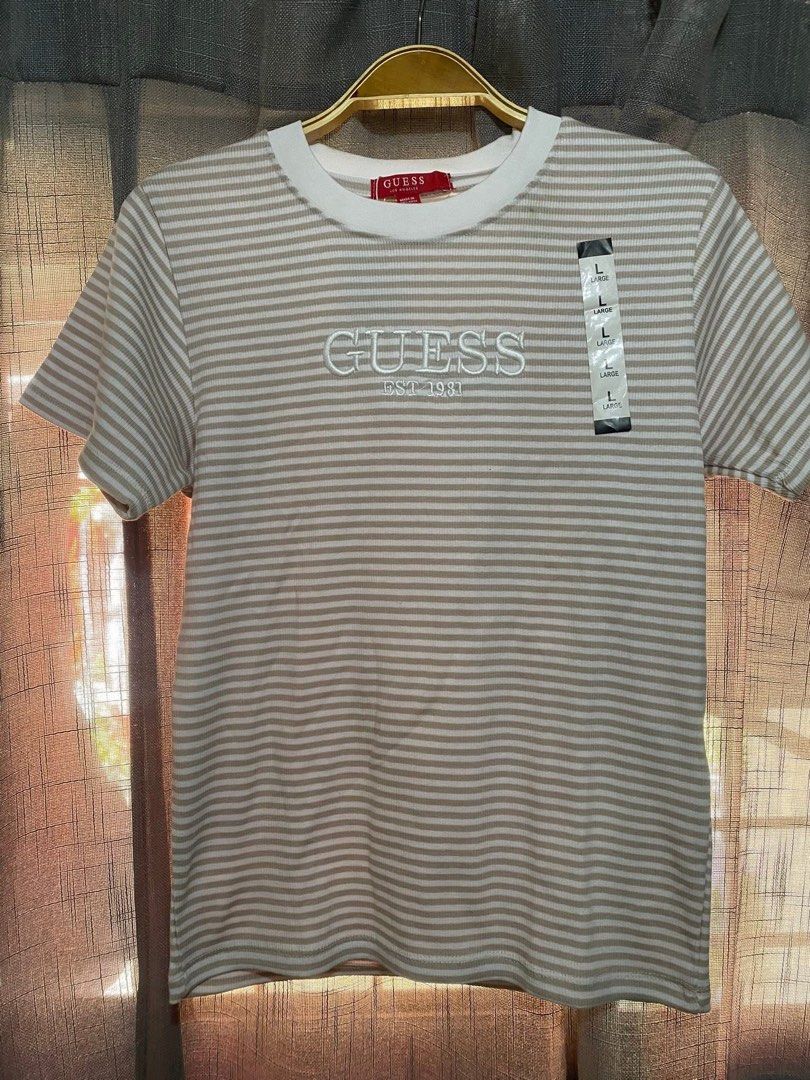Guess Striped T-Shirt - Size L (Category: Shirts) located in Cavite. Submitted by Abril_07 (Listing ID 1438877034, Image 1). Description: - Guess striped t-shirt (stretchable) - Size: L - Features embroidered Guess logo - Round neckline, short sleeves - Made in Bangladesh.