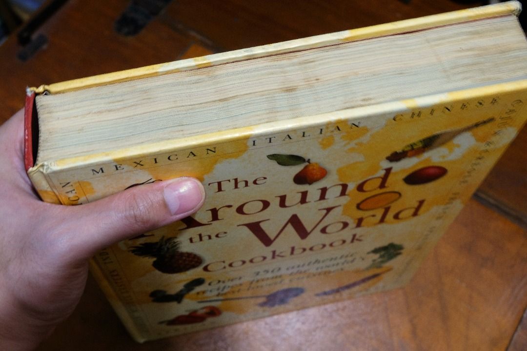 [HARDCOVER] The Around the World Cookbook (Category: Storybooks) located in Binan City. Submitted by matupictu (Listing ID 1438806849, Image 2). Description: - Over 350 recipes from around the world - Each chapter covers a cuisine particular to a country or region. - Well-loved cookbook with some signs of use.
