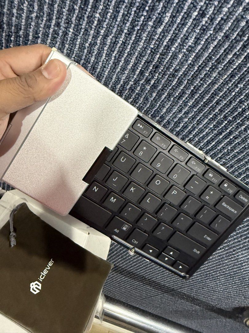iClever Backlit Metal Folding Keyboard (Category: Computer Keyboard) located in Manila. Submitted by zeuxthegreekgod (Listing ID 1438700826, Image 3). Description: Selling this compact, tri-fold keyboard. Perfect for working on your tablet or phone on the go! Key Features: • Ultra-Portable: Tri-fold design with a durable aluminum back. • Backlit: 3 colors (Red/Blue/Green) with adjustable brightness. • Multi-Device: Connect and switch between up t