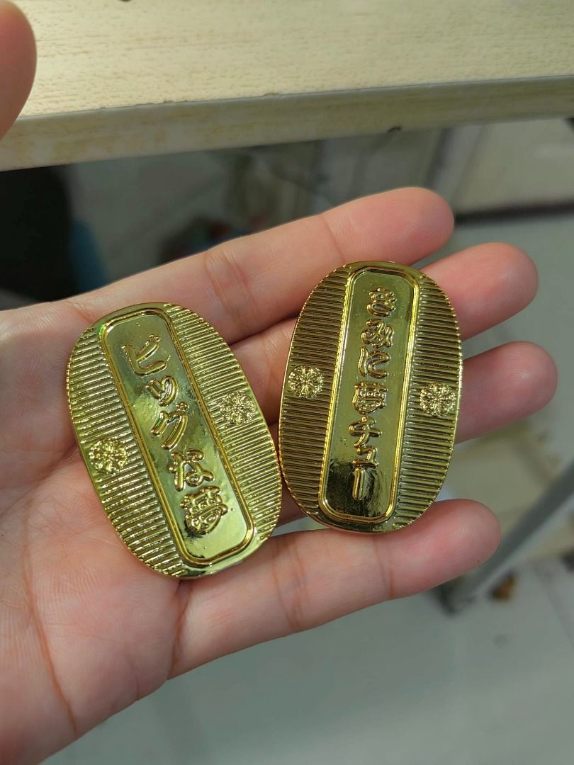 Japanese-style lucky charm (Category: Other Accessories) located in Cebu City. Submitted by dudes_villanueva (Listing ID 1438795088, Image 2). Description: Japanese-style lucky charm 📌 modeled after a traditional Koban (oval gold coin). It is embossed with a stylized character resembling a bear and mouse, inscribed with specific text to invite good fortune..