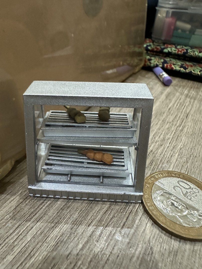 j.dream: Miniature Grill with Skewers (Category: BBQ, Grills & Hotpots) located in Muntinlupa City. Submitted by camotepie (Listing ID 1438826257, Image 1). Description: - Miniature silver rectangular grill - Two grilling levels - Includes two skewers (clay-like material) - 20-peso coin for size reference only.