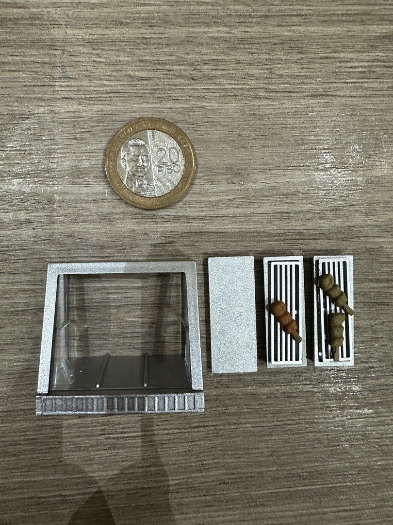 j.dream: Miniature Grill with Skewers (Category: BBQ, Grills & Hotpots) located in Muntinlupa City. Submitted by camotepie (Listing ID 1438826257, Image 2). Description: - Miniature silver rectangular grill - Two grilling levels - Includes two skewers (clay-like material) - 20-peso coin for size reference only.