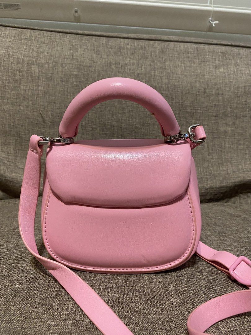 Kunogigi Pink Pigpig hand bag (Category: Tote Bags) located in Calamba. Submitted by jupreloved_ (Listing ID 1438731847, Image 2). Description: Pink Kunogigi handbag. Features a top handle, detachable shoulder strap, and unique clasp closure. Interior is pink. Brand: Kunogigi Size: Small Shipping through J&T. Payment are strictly through GCASH only, no COD. Exact size and color may be different from the picture. This is a preloved item, please ma