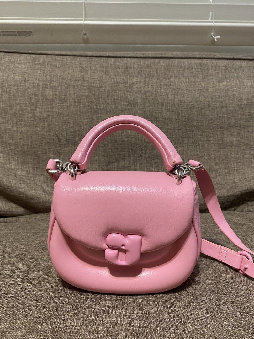 Kunogigi Pink Pigpig hand bag (Category: Tote Bags) located in Calamba. Submitted by jupreloved_ (Listing ID 1438731847, Image 1). Description: Pink Kunogigi handbag. Features a top handle, detachable shoulder strap, and unique clasp closure. Interior is pink. Brand: Kunogigi Size: Small Shipping through J&T. Payment are strictly through GCASH only, no COD. Exact size and color may be different from the picture. This is a preloved item, please ma