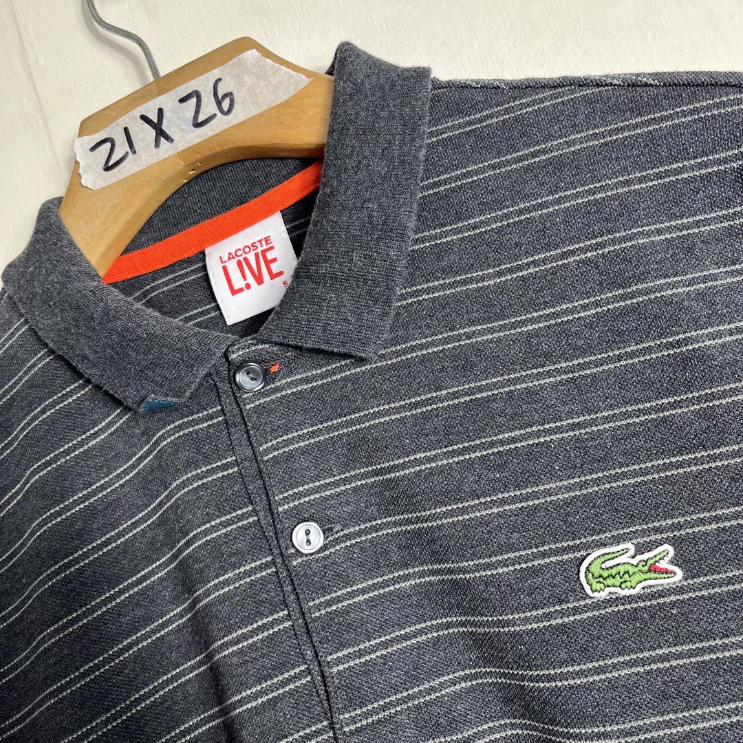 Lacoste Live Striped Polo Shirt (Category: Tshirts & Polo Shirts ) located in Manila. Submitted by direcmampu37948 (Listing ID 1438841157, Image 3). Description: - Lacoste Live polo shirt - Size: 5 - Color: Gray with white stripes - Orange accents on sleeves - Classic polo collar - Features the Lacoste crocodile logo - Button-up placket.