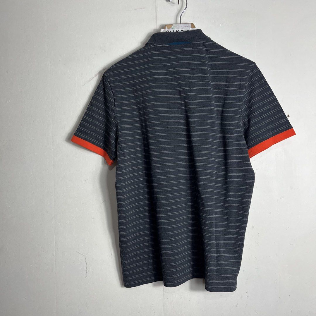 Lacoste Live Striped Polo Shirt (Category: Tshirts & Polo Shirts ) located in Manila. Submitted by direcmampu37948 (Listing ID 1438841157, Image 2). Description: - Lacoste Live polo shirt - Size: 5 - Color: Gray with white stripes - Orange accents on sleeves - Classic polo collar - Features the Lacoste crocodile logo - Button-up placket.