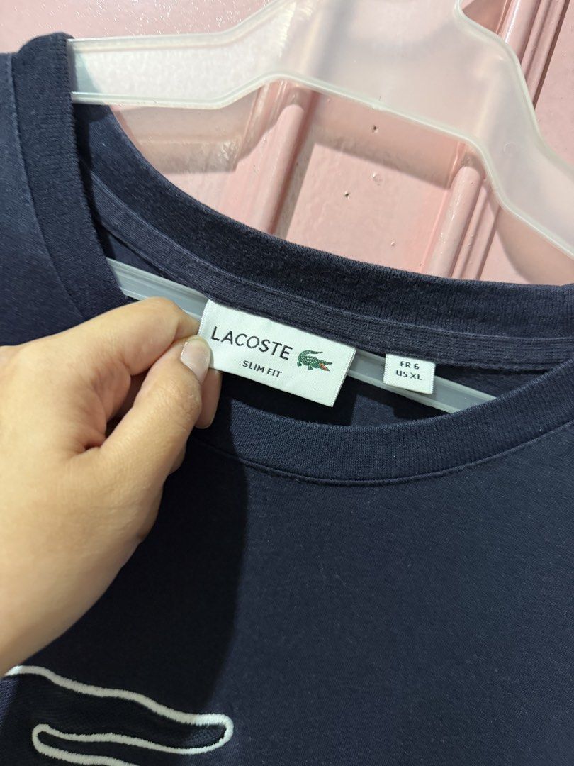 Lacoste Slim Fit T-shirt - US XL (Category: Tshirts & Polo Shirts ) located in Pasig City. Submitted by inmyclosetbyj (Listing ID 1438836065, Image 2). Description: - Lacoste Slim Fit T-shirt - Color: Navy Blue - Size: US XL - Iconic crocodile logo with white outline - Crew neck - Short sleeves - Tag visible in photos.