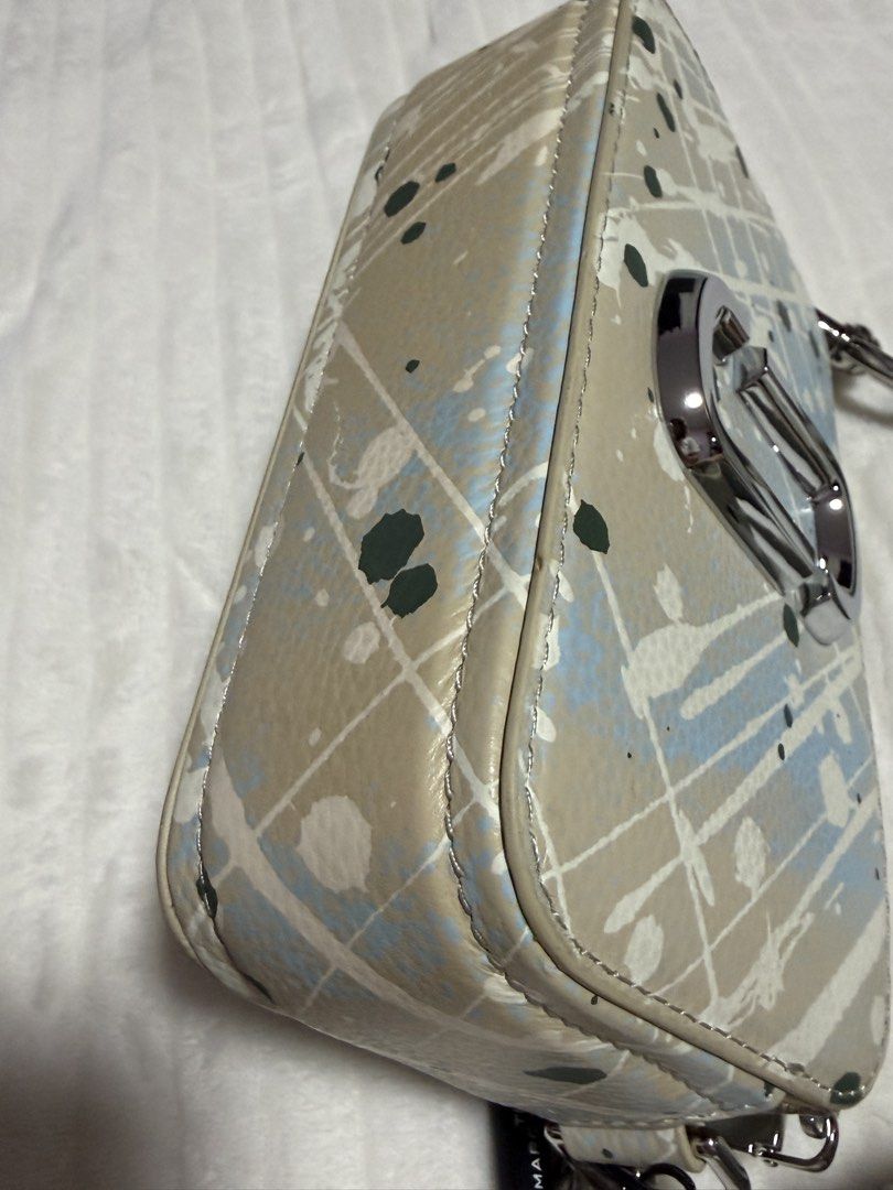 Marc Jacobs The Snapshot Crossbody Bag (Category: Luxury Bags & Wallets) located in Angono. Submitted by annabela8910 (Listing ID 1438777614, Image 2). Description: - Authentic Marc Jacobs crossbody bag - Eye-catching paint splatter design - Rectangular shape with zip closure - Detachable strap with matching paint splatter design - Features the signature 'J' logo - Compact and ideal for everyday use.