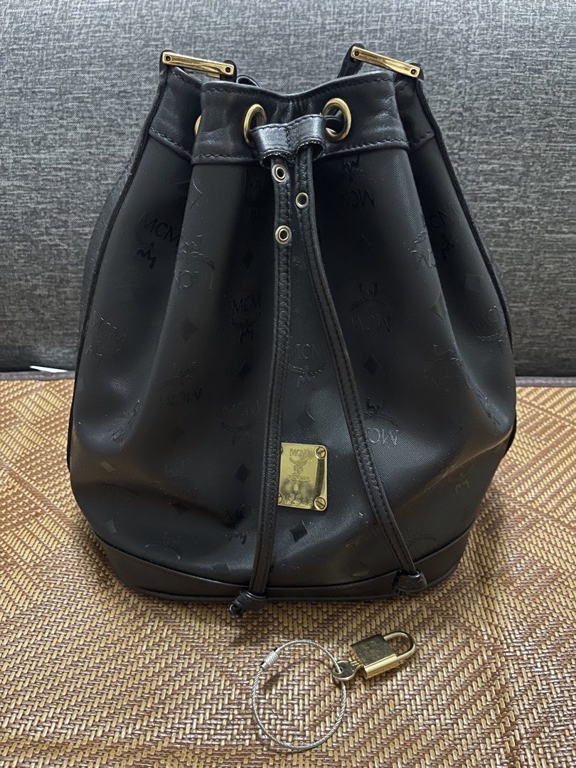 MCM Black Bucket Bag (Category: Luxury Bags & Wallets) located in Valenzuela. Submitted by bekikemper (Listing ID 1438733555, Image 1). Description: - Authentic MCM bucket bag - Black color - Drawstring closure - Gold-tone metal logo plate and hardware - Detachable shoulder strap - Interior zippered pocket - MCM logo lining - Includes lock and key -Bought sa Japan. NOTE: WALA PONG BOX AT DUST BAG ITONG BAG. Rush lang po for my mom’s chemo meds. S