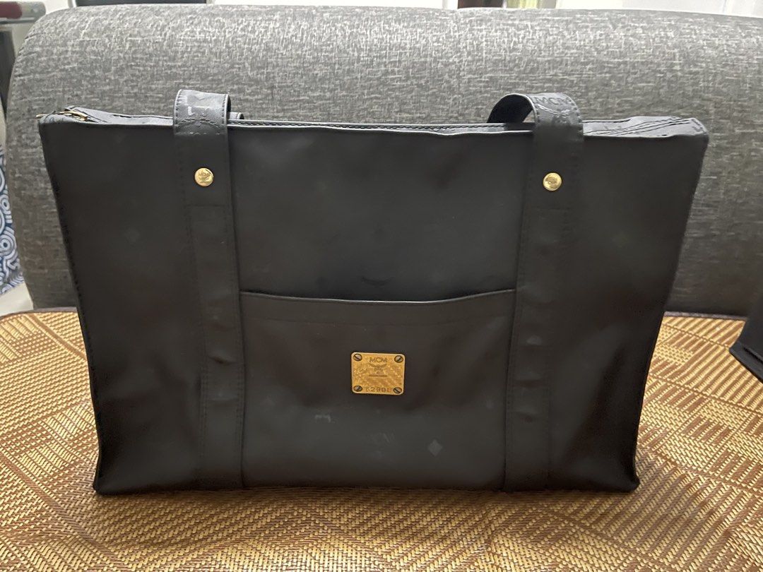 MCM Black Tote Bag (Category: Luxury Bags & Wallets) located in Valenzuela. Submitted by bekikemper (Listing ID 1438733210, Image 1). Description: - Black MCM tote bag - Features front pocket with MCM logo - Zipper closure - Long shoulder straps - Interior black organizer - MCM logo pattern throughout - Made of a nylon-like material - Bought last year in Japan. NOTE: WALA PONG BOX AT DUST BAG ITONG BAG. Rush lang po for my mom’s chemo meds. Salam