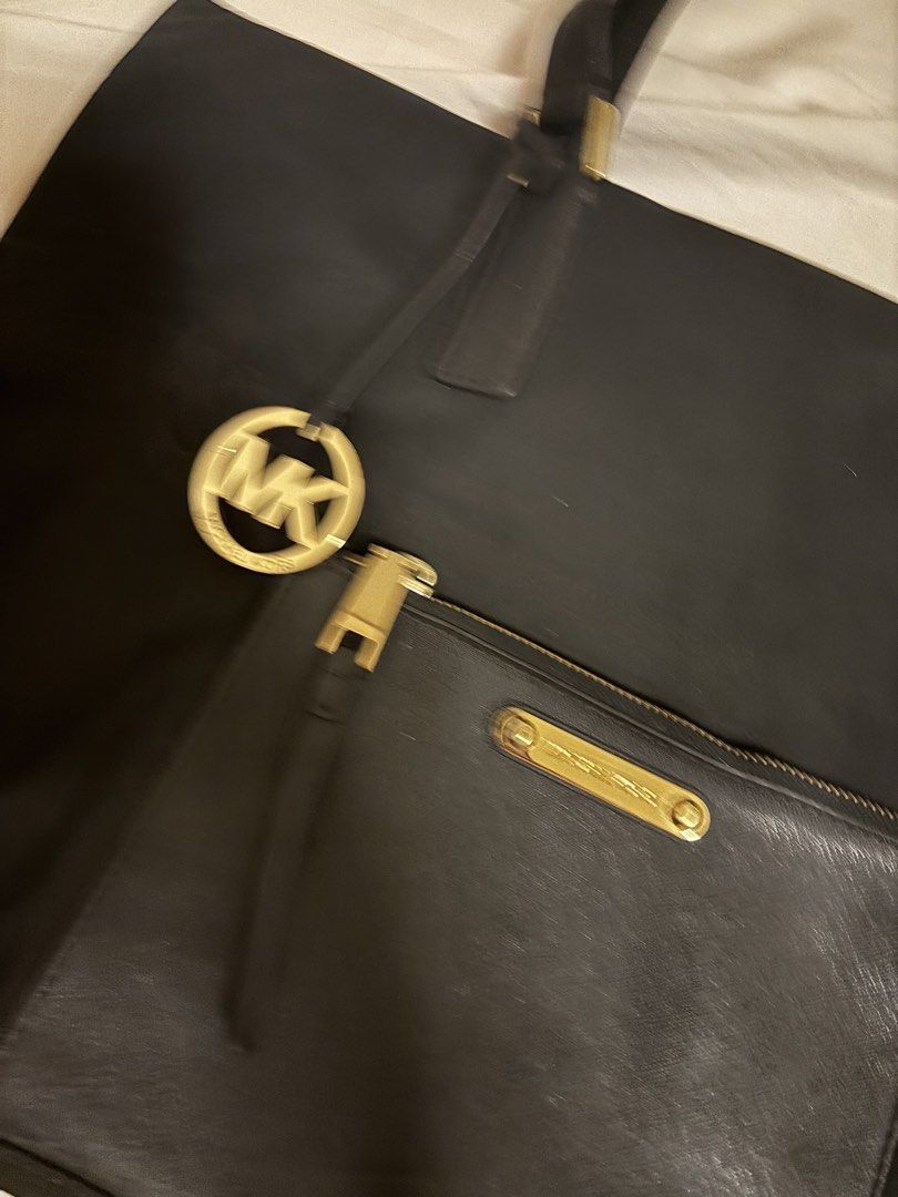 Michael Kors Black Tote Bag (Category: Tote Bags) located in Pasig City. Submitted by lxtld11 (Listing ID 1438716108, Image 2). Description: - Black Michael Kors tote bag - Front zip pocket with Michael Kors logo - Dual handles - Gold-colored zipper - Black interior with Michael Kors logo print.