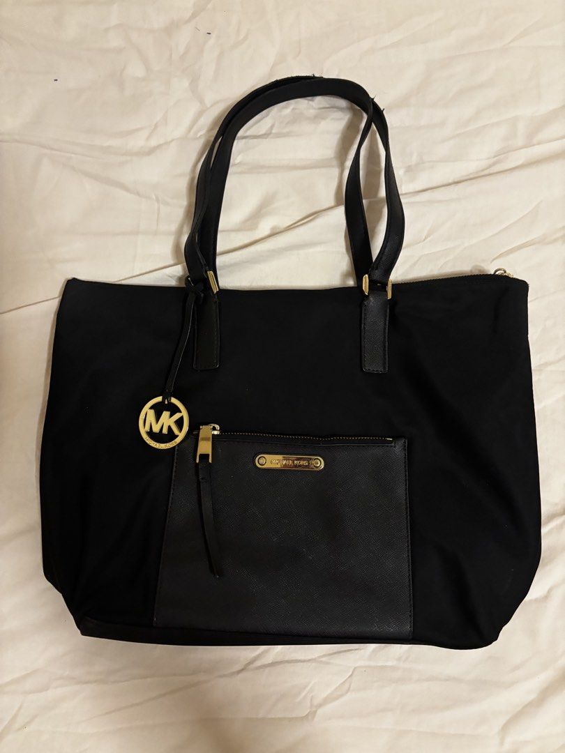 Michael Kors Black Tote Bag (Category: Tote Bags) located in Pasig City. Submitted by lxtld11 (Listing ID 1438716108, Image 1). Description: - Black Michael Kors tote bag - Front zip pocket with Michael Kors logo - Dual handles - Gold-colored zipper - Black interior with Michael Kors logo print.