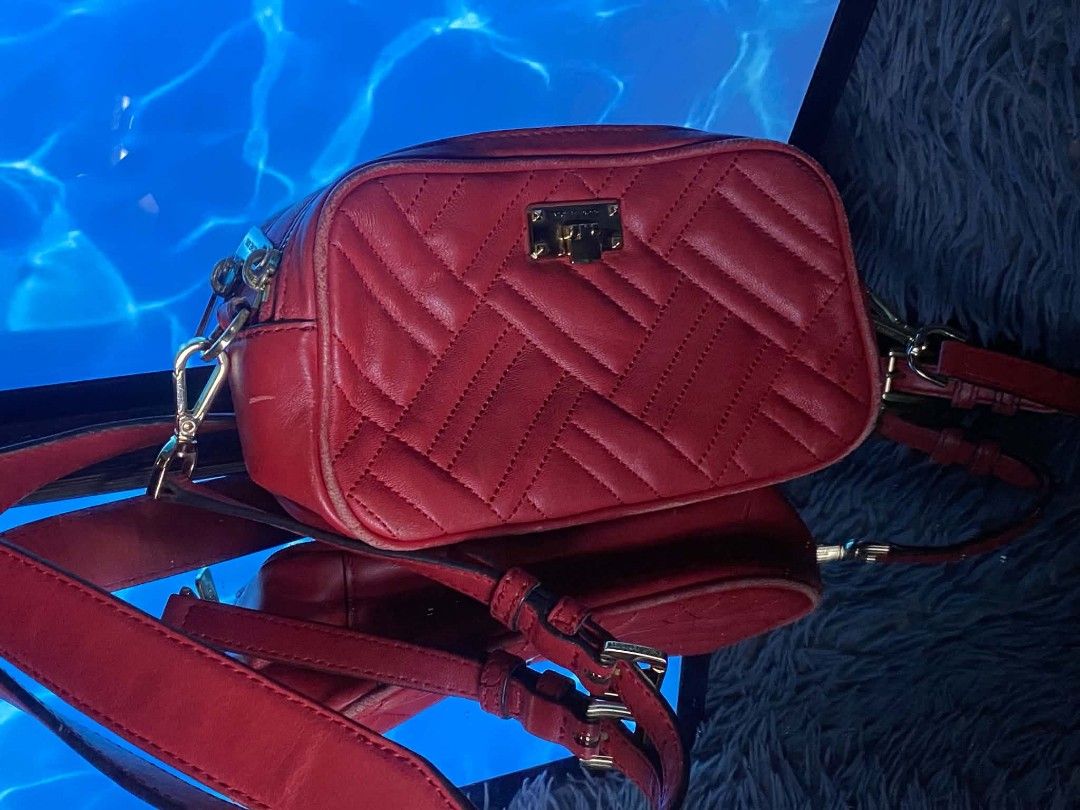 MICHAEL KORS RED CROSS BODY BAG (Category: Luxury Bags & Wallets) located in Cavite. Submitted by charis364 (Listing ID 1438817462, Image 1). Description: -Aunthentic Michael kors crossbody bag. interior hologram lining -color Red ,gold zipper.with small Michael kors tag. ideal for carrying.essentials.