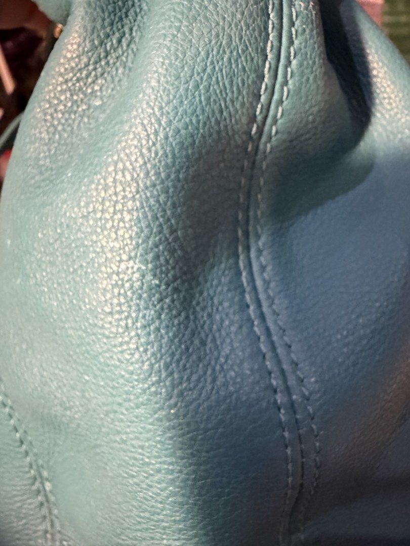 Michael Kors Turquoise Hobo Bag (Category: Luxury Bags & Wallets) located in Muntinlupa City. Submitted by everythingmustgo_8475da (Listing ID 1438697217, Image 3). Description: - Authentic Michael Kors hobo bag - Color: Turquoise - Hardware: Gold-tone - Includes chain strap and shoulder strap - Spacious interior - Minor signs of wear on leather - Stitching intact - Well-maintained shape.