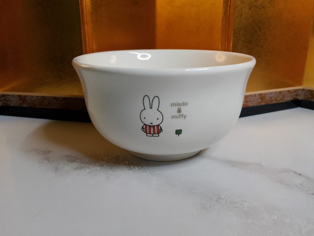 Miffy x Misdo Ceramic Bowl (Category: Other Kitchenware & Tableware) located in Valenzuela. Submitted by buylaaaaa (Listing ID 1438785222, Image 1). Description: - Miffy x Misdo ceramic bowl - Features a white exterior with Miffy illustration, clover, and a quote - Bottom marked with Miffy logo and "Produced by Mister Donut" - Approximately 10cm diameter - Approximately 7cm height.