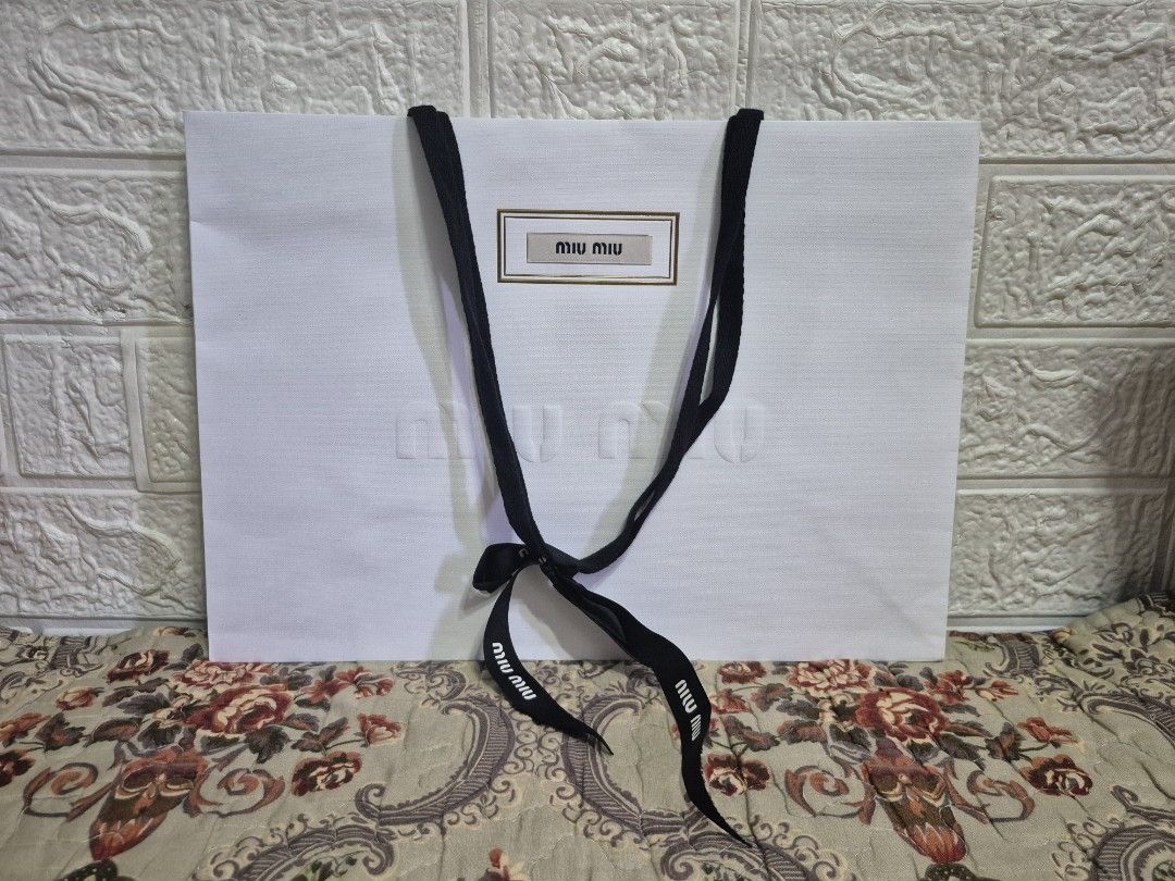 Miu Miu Paper Bag with ribbon (Category: Luxury Accessories) located in Pasig City. Submitted by luxbox_acc (Listing ID 1438696438, Image 3). Description: Large rose pink- 800 medium rose pink-650 SOLD medium white-650 I have card holder/envelope for sale also.