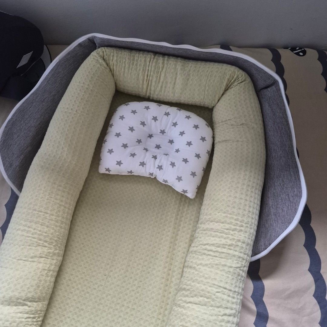 Newborn co-sleeping bed (Category: Cots & Cribs) located in Cavite. Submitted by sydslittlecorner (Listing ID 1438790511, Image 2). Description: • Bought at the orange app for P1,299 • Added pillow fillings to the sides of the bed to make it more firm yet soft • Only used for 1 month ● Good for newborn babies and parents who plan to co-sleep • Dimensions: 99 x 55 x 15.