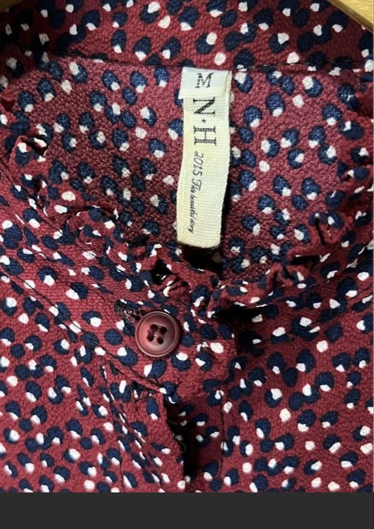 N.H. Floral Blouse - Size M (Category: Blouses) located in Malabon City. Submitted by igigs (Listing ID 1438757580, Image 2). Description: - Brand: N.H - Color: Maroon with floral pattern - Features: Long sleeves with ruffled cuffs, high neckline with ruffle detail, button-down front - Size: M.