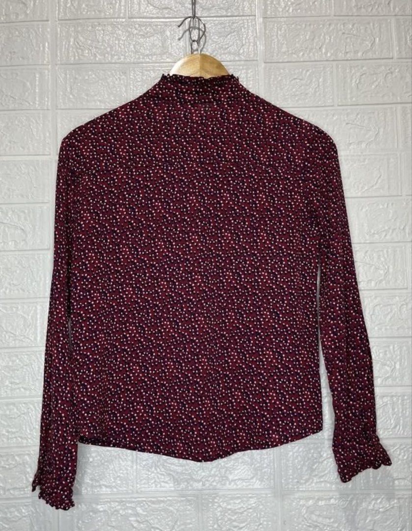 N.H. Floral Blouse - Size M (Category: Blouses) located in Malabon City. Submitted by igigs (Listing ID 1438757580, Image 3). Description: - Brand: N.H - Color: Maroon with floral pattern - Features: Long sleeves with ruffled cuffs, high neckline with ruffle detail, button-down front - Size: M.