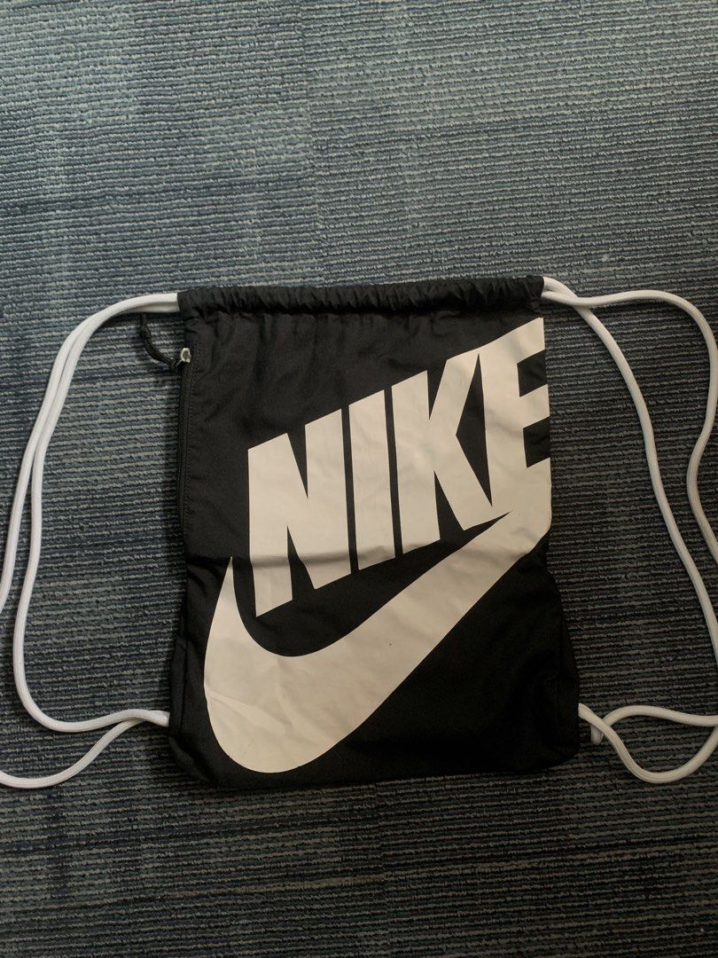 Nike Drawstring Bag (Category: Backpacks) located in Pasay City. Submitted by Oboyyy (Listing ID 1438746426, Image 1). Description: - Black Nike drawstring bag - Features a large white Nike logo - White drawstring straps - Made of durable polyester - Made in China Used no issue 590 pesos.