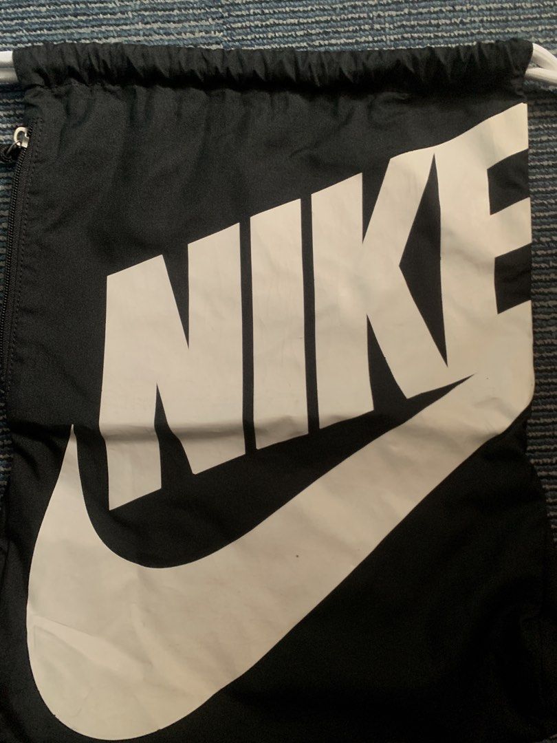 Nike Drawstring Bag (Category: Backpacks) located in Pasay City. Submitted by Oboyyy (Listing ID 1438746426, Image 2). Description: - Black Nike drawstring bag - Features a large white Nike logo - White drawstring straps - Made of durable polyester - Made in China Used no issue 590 pesos.