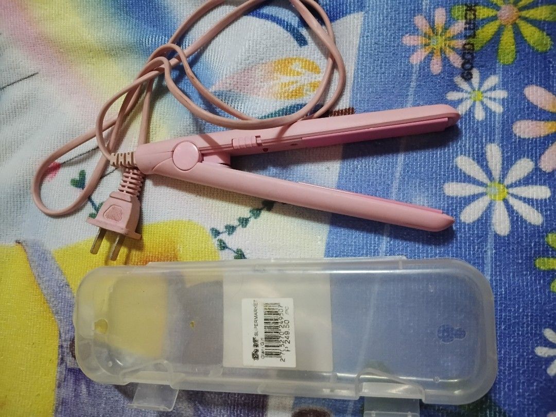 Pink Mini Hair Straightener with Case (Category: Hair) located in Quezon City. Submitted by xorei (Listing ID 1438719209, Image 2). Description: - Pink hair straightener - Matching pink cord - Clear plastic storage case included - Simple, single-button design - Two-prong plug - Ready to use.