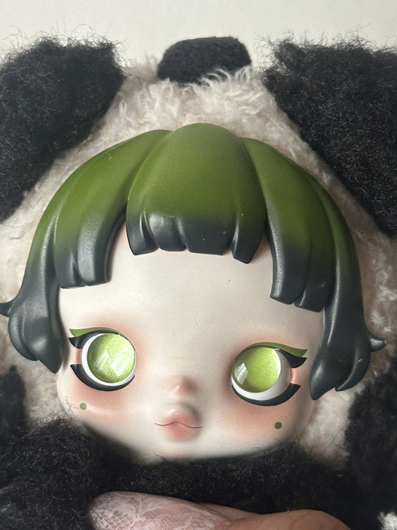 Popmart SkullPanda Lazy Panda Doll Keychain (Category: Plushies & Soft Toys) located in Quezon City. Submitted by shopalmostfriday (Listing ID 1438694059, Image 3). Description: - Adorable Skull Panda doll keychain. - Features a panda plushie with a doll face. - Doll has green hair and green eyes. - Panda plushie has black and white fur. - Includes a keychain ring for easy attachment. - Comes with a small bamboo charm. - with blister box.