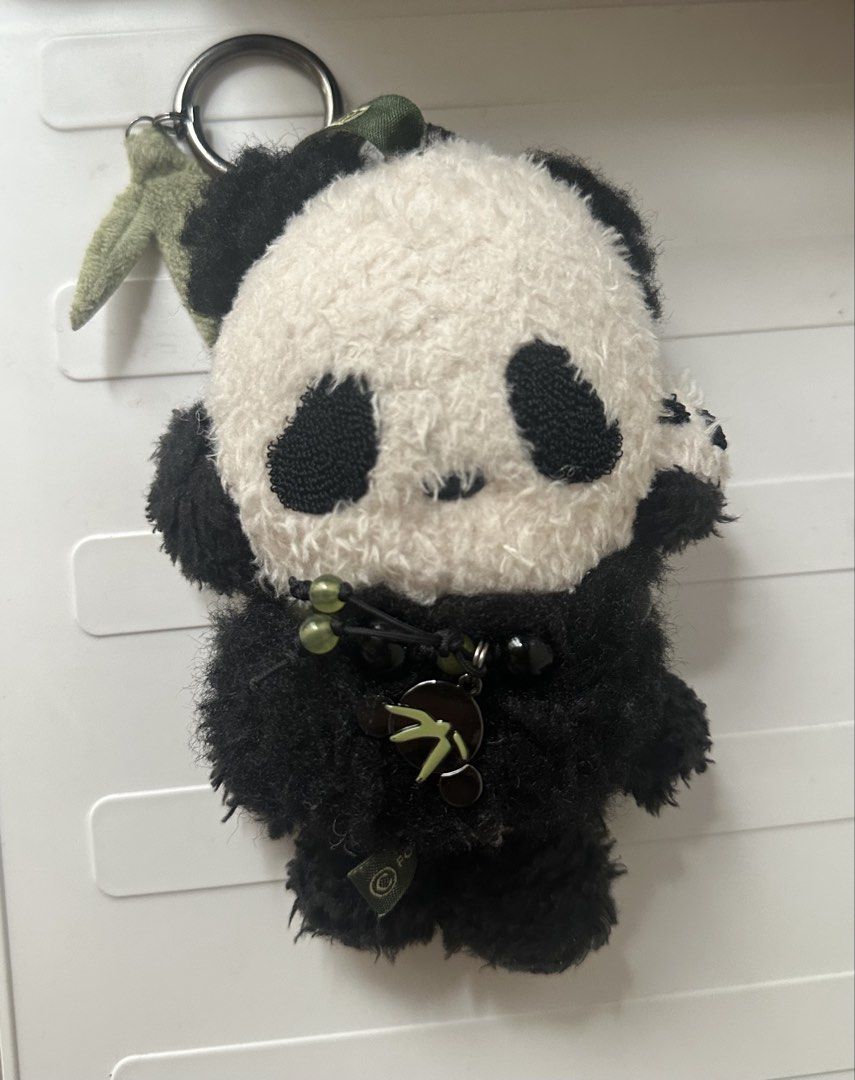Popmart SkullPanda Lazy Panda Doll Keychain (Category: Plushies & Soft Toys) located in Quezon City. Submitted by shopalmostfriday (Listing ID 1438694059, Image 2). Description: - Adorable Skull Panda doll keychain. - Features a panda plushie with a doll face. - Doll has green hair and green eyes. - Panda plushie has black and white fur. - Includes a keychain ring for easy attachment. - Comes with a small bamboo charm. - with blister box.