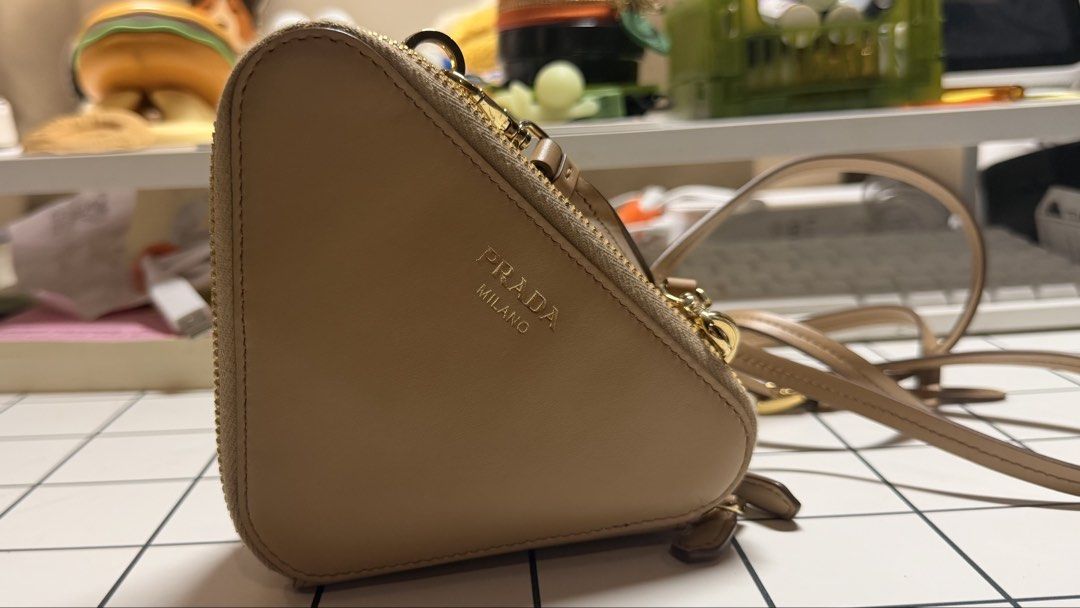 Prada Crochet Mini Pouch (Category: Luxury Bags & Wallets) located in Antipolo. Submitted by sophiamads (Listing ID 1438810022, Image 2). Description: - Prada Triangle Crossbody Bag - Woven raffia exterior - Neutral beige color - Detachable strap - Double-compartment interior - Gold-toned hardware - Zipper closure - Used twice only - Price is negotionable.