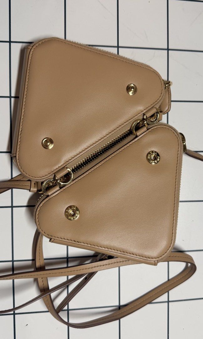 Prada Crochet Mini Pouch (Category: Luxury Bags & Wallets) located in Antipolo. Submitted by sophiamads (Listing ID 1438810022, Image 3). Description: - Prada Triangle Crossbody Bag - Woven raffia exterior - Neutral beige color - Detachable strap - Double-compartment interior - Gold-toned hardware - Zipper closure - Used twice only - Price is negotionable.