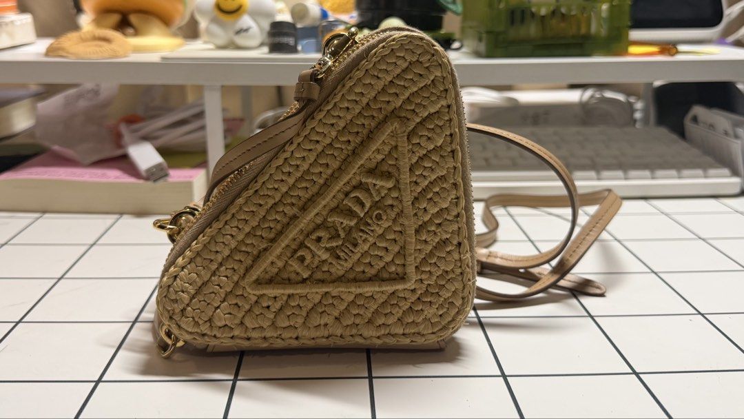 Prada Crochet Mini Pouch (Category: Luxury Bags & Wallets) located in Antipolo. Submitted by sophiamads (Listing ID 1438810022, Image 1). Description: - Prada Triangle Crossbody Bag - Woven raffia exterior - Neutral beige color - Detachable strap - Double-compartment interior - Gold-toned hardware - Zipper closure - Used twice only - Price is negotionable.