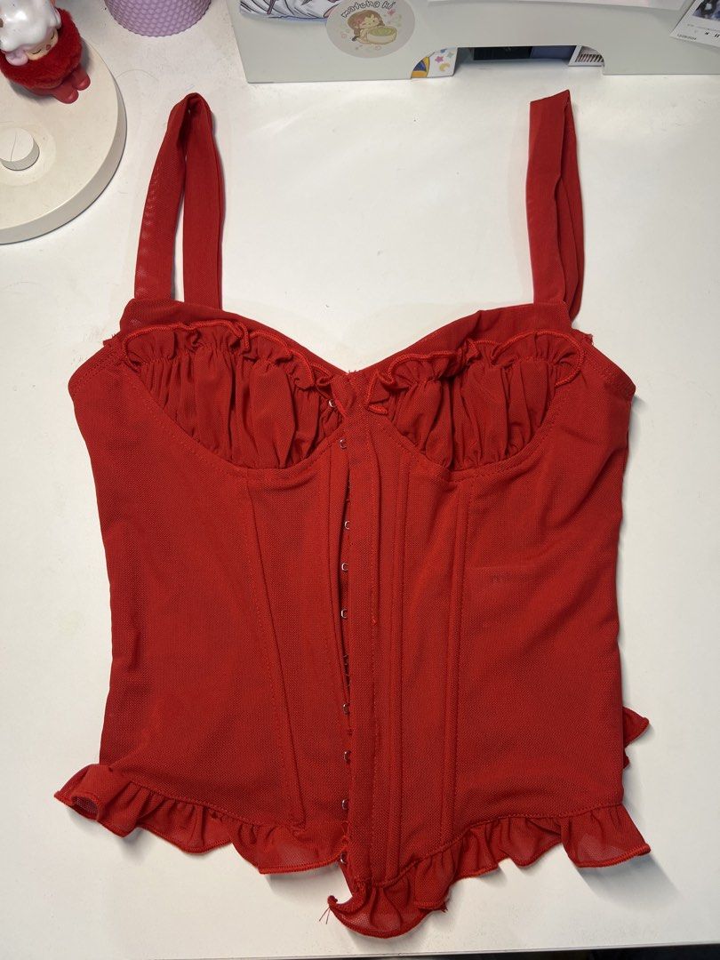 Red Corset Top with Ruffle Detail (Category: Sleeveless) located in Muntinlupa City. Submitted by kkiswardrobe (Listing ID 1438729189, Image 2). Description: - Red corset top - Sweetheart neckline - Delicate ruffle trim - Adjustable straps - Hook-and-eye closure - Structured fabric - Great for a night out or special events.