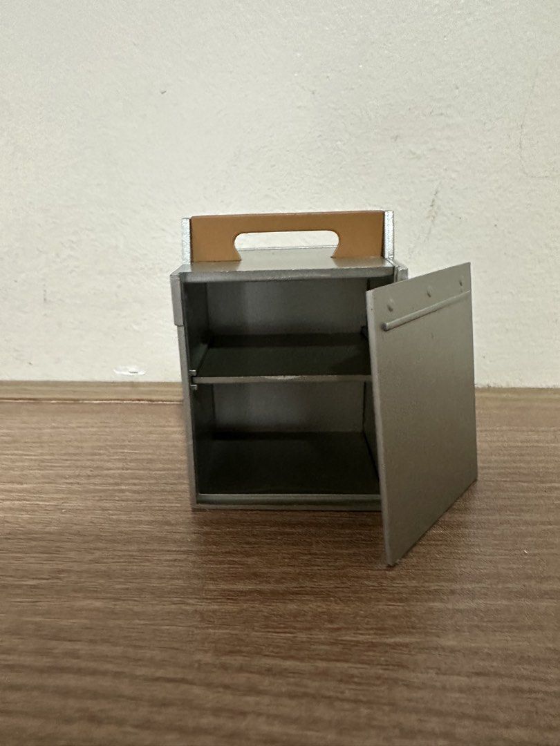 Rement Metal Storage Box with Handle (Category: Storage Boxes & Baskets) located in Muntinlupa City. Submitted by camotepie (Listing ID 1438770401, Image 2). Description: - Metal storage box - Features a handle for easy carrying - Hinged door - Two shelves inside - Neutral color - Simple, functional design - Suitable for various storage needs.