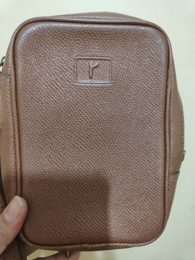 Renoma Brown CP Crossbody Bag (Category: Luxury Bags & Wallets) located in Paniqui. Submitted by arlenepari29210 (Listing ID 1438758211, Image 3). Description: - Brown crossbody bag - Rectangular shape - Zipper closure - Adjustable strap - Small logo detail - Lined interior - Textured material.