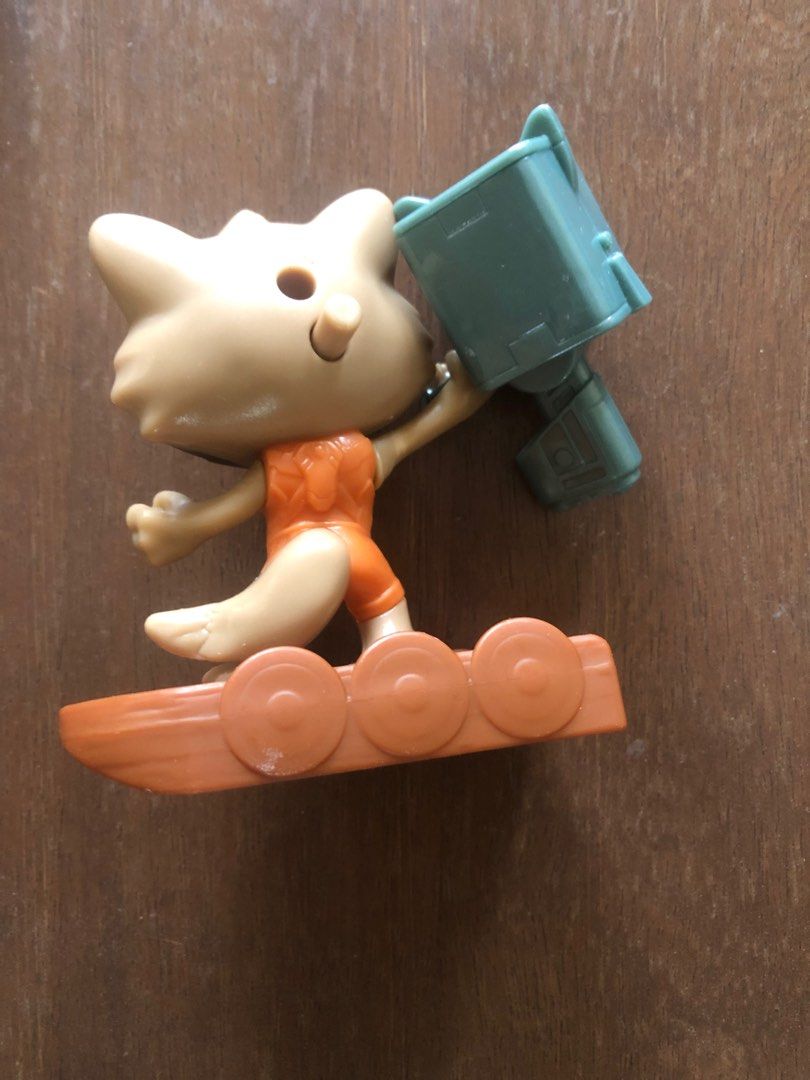 Rocket Raccoon Toy Figure (Category: Figurines & Statues) located in Pasig City. Submitted by vintagely (Listing ID 1438785130, Image 2). Description: - Rocket Raccoon figure - Riding a brown surfboard - Wearing an orange jumpsuit - Holding a light blue weapon - Features a black mask 3.8x3.8”.