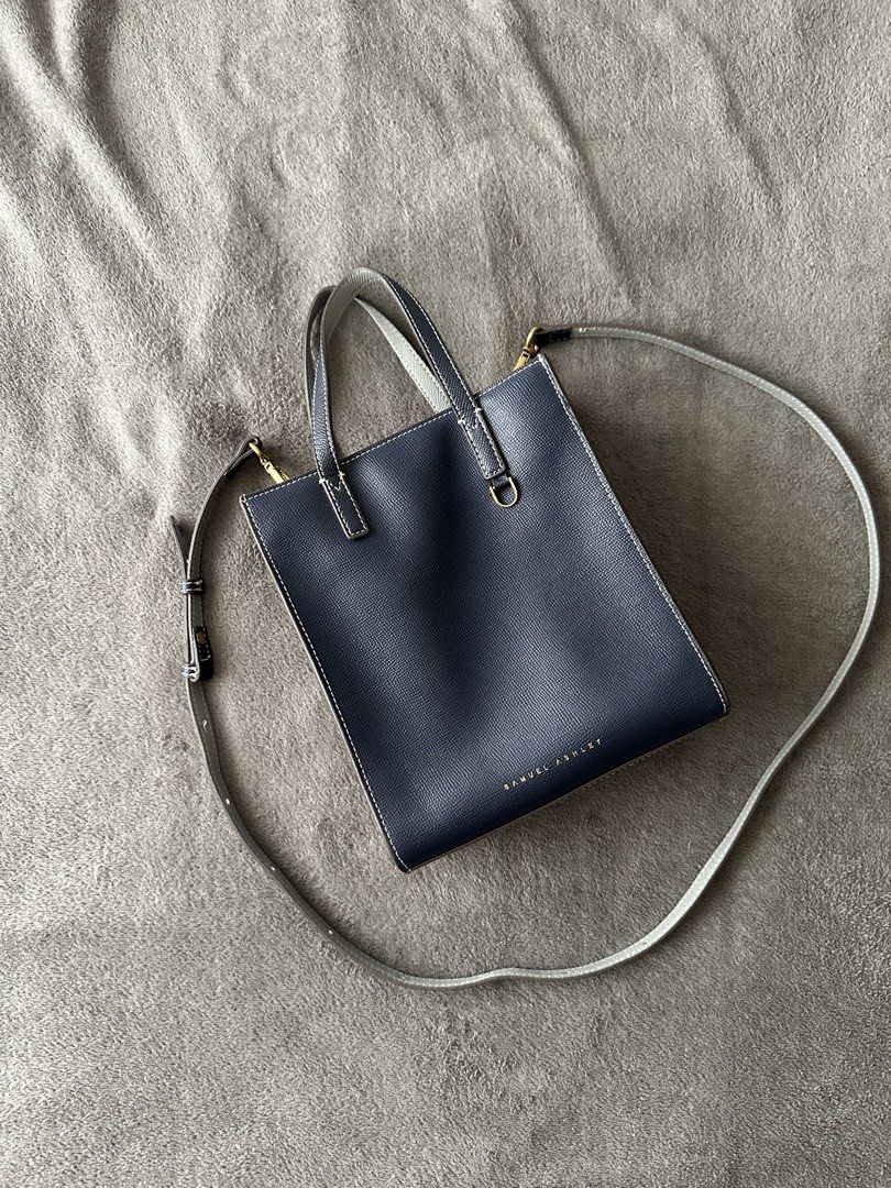 Samuel Ashley Navy Body Bag (Two Way) (Category: Tote Bags) located in Lipa City. Submitted by bagabonds (Listing ID 1438712470, Image 1). Description: - Detachable body strap - Top handles - White stitching - Gold-colored hardware - Brand name visible - Textured leather material Don't be shy to ask for photos ☺️.