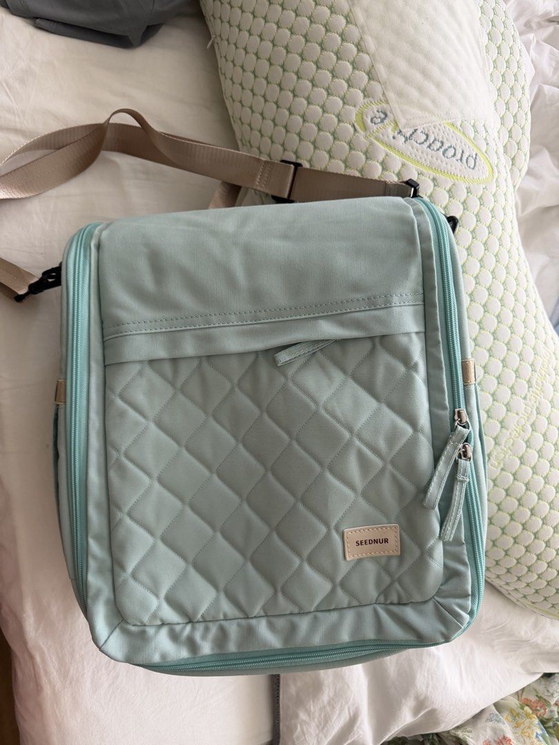 Seednur Baby Bag with changing pad (Category: Babies & Kids Fashion) located in Makati City. Submitted by inezlebron (Listing ID 1438849307, Image 3). Description: - Mint green Seednur baby bag - Quilted front design - Detachable shoulder strap - Polka dot interior - Includes padded insert - Ideal for baby travel -very spacious.