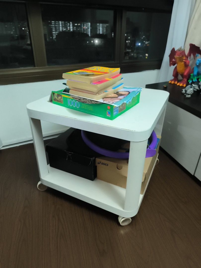 Side Table (Category: Tables & Sets) located in Singapore. Submitted by living_simple (Listing ID 1438835714, Image 1). Description: [moving out clearance]- two IKEA tables to let go. 1) white curved edge w wheels - $7 - laminate at the edges are coming apart slightly.. - one of the wheels is a little faulty in the sense that the cap keeps coming off.. can still be rolled around though replacement might be good. - still sturdy and functional.grea
