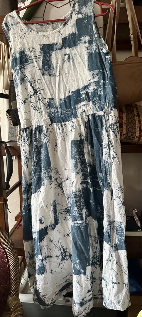 Sleeveless Printed Summer Dress (Category: Dresses) located in Quezon City. Submitted by declutter_incorporated (Listing ID 1438755271, Image 1). Description: - Sleeveless dress with a unique blue and white print. - Features a flattering gathered waist. - Comfortable round neckline. - Made from lightweight fabric, perfect for warm weather. - Relaxed fit. - Mid-calf length. - Ideal for casual outings and the beach..