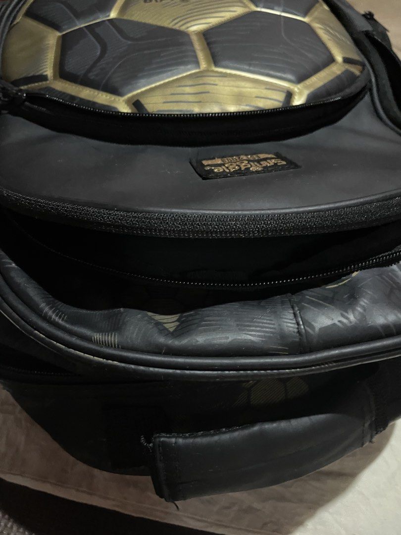 Smiggle Soccer Ball Rolling Backpack (Category: Diaper Bags & Wetbags) located in Manila. Submitted by real17 (Listing ID 1438842772, Image 2). Description: - Smiggle rolling backpack - Soccer ball design - Black and gold color scheme - Multiple compartments - Handle for carrying - Wheels for easy transport - Smiggle logo detail WHEN IN DOUBT, DONT BUY. LAST PRICE POSTED.
