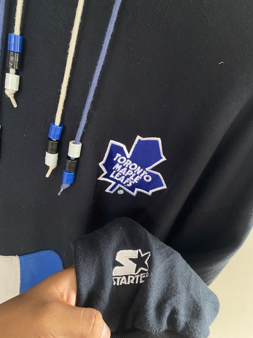 Starter Toronto Maple Leafs Hoodie XL (Category: Coats, Jackets and Outerwear) located in Manila. Submitted by jsprtalens10988 (Listing ID 1438783974, Image 2). Description: - Vintage Starter hoodie - Toronto Maple Leafs logo - Navy blue body with grey and blue hood and pocket accents - XL size - Made in Korea - Starter logo on sleeve and back - Minor wear and tear on pocket.