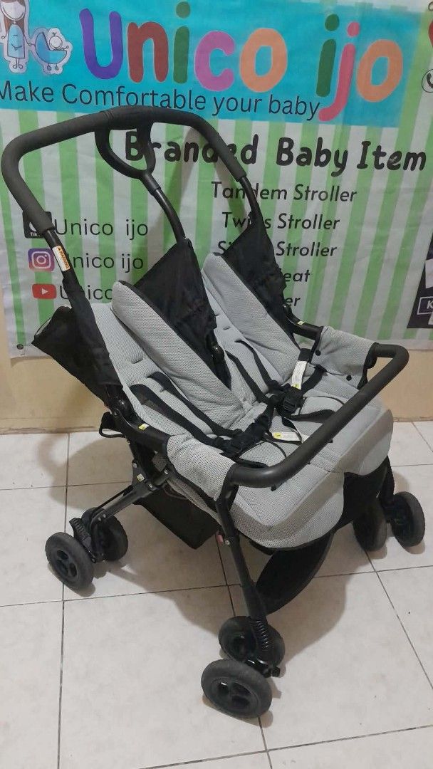 Tandem Stroller (Category: Strollers) located in Caloocan City. Submitted by Unicoijo02 (Listing ID 1438697152, Image 3). Description: - Tandem stroller for two babies. - Two seats with safety harnesses. - Protective canopies included. - Black frame with stylish gray seating. - Foldable for convenient storage and transport. - Black wheels. - Ergonomic curved handle for comfortable pushing..