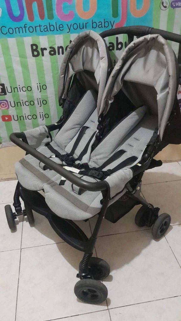 Tandem Stroller (Category: Strollers) located in Caloocan City. Submitted by Unicoijo02 (Listing ID 1438697152, Image 1). Description: - Tandem stroller for two babies. - Two seats with safety harnesses. - Protective canopies included. - Black frame with stylish gray seating. - Foldable for convenient storage and transport. - Black wheels. - Ergonomic curved handle for comfortable pushing..