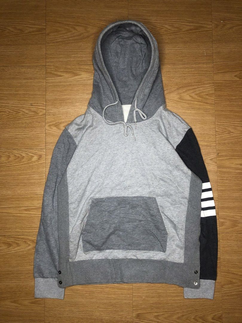Thom Browne Colorblock Hoodie (Category: Coats, Jackets and Outerwear) located in Quezon City. Submitted by yeahsource222 (Listing ID 1438750289, Image 1). Description: - Thom Browne hoodie - Colorblock design: Grey body, black sleeve with white stripes - Features a hood with drawstrings - Kangaroo pocket - Buttoned cuffs - Made in Japan - Material: 100% cotton.