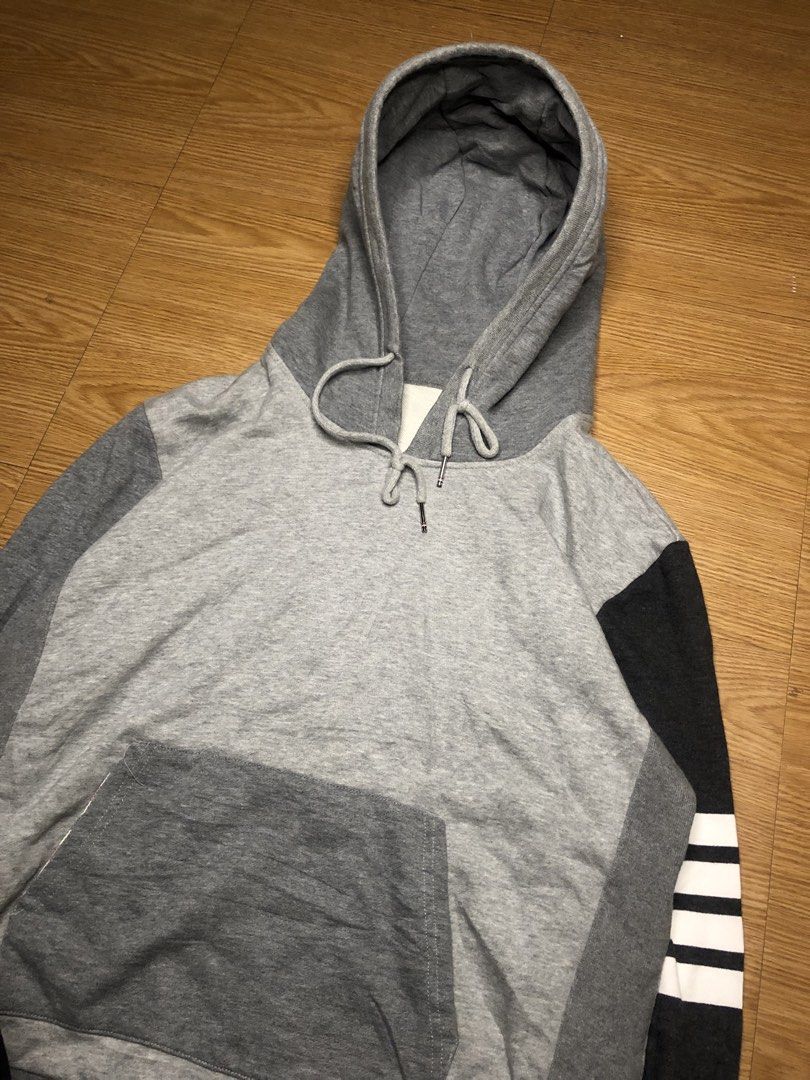 Thom Browne Colorblock Hoodie (Category: Coats, Jackets and Outerwear) located in Quezon City. Submitted by yeahsource222 (Listing ID 1438750289, Image 2). Description: - Thom Browne hoodie - Colorblock design: Grey body, black sleeve with white stripes - Features a hood with drawstrings - Kangaroo pocket - Buttoned cuffs - Made in Japan - Material: 100% cotton.