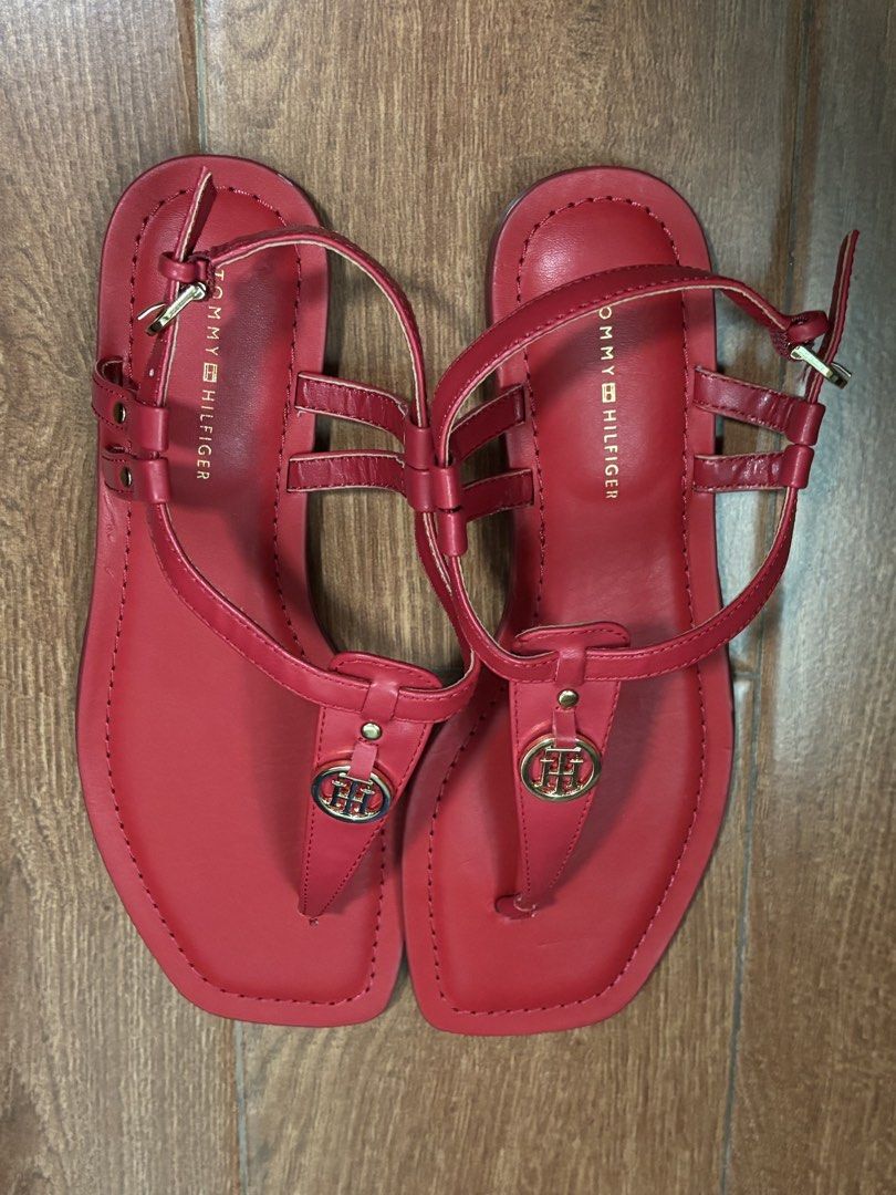Tommy Hilfiger Jerika Red Thong Sandals (Category: Flats & Sandals) located in Cagayan de Oro. Submitted by cristine.s (Listing ID 1438708098, Image 2). Description: Red Tommy Hilfiger Thongs Sandals Model: Jerika Size: US 7 New from US retails $89 USD; never worn ❗️With flaw: Slight chipped off in the toe strap. See last photo posted. Not noticeable when worn. Design: T-strap with gold-tone logo Closure: Buckle for adjustable fit like zara mango