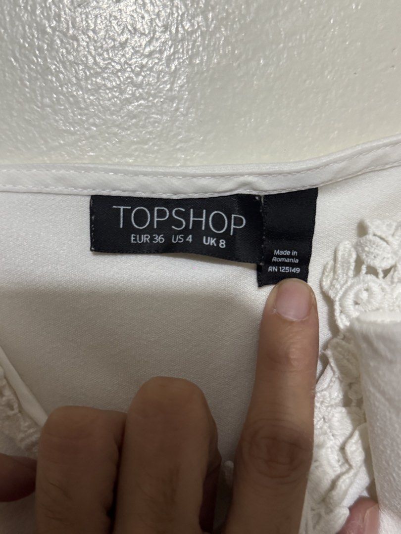 Topshop White Lace-Up Bodysuit (Category: Others Tops) located in Quezon City. Submitted by maxmaximoo (Listing ID 1438878782, Image 3). Description: - Topshop white bodysuit - Lace-up detail - Delicate lace trim - Scoop neckline and spaghetti straps - Size: EUR 36, UK 8, US 4 - Made in Romania - Smooth, solid white fabric.