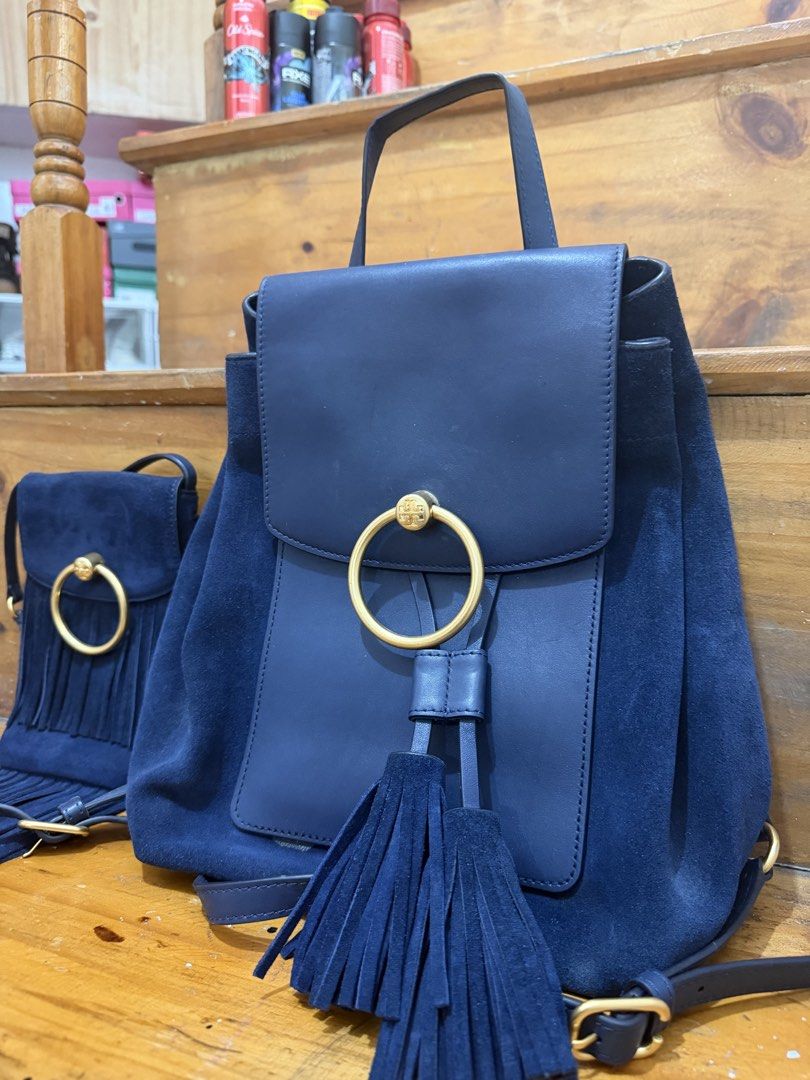 Tory Burch Bag Set (Category: Luxury Bags & Wallets) located in Baguio. Submitted by clemens031 (Listing ID 1438787175, Image 2). Description: - Navy blue backpack and crossbody bag set - Features a suede-like material - Gold-tone ring detail and tassel accents on both bags - Backpack: Flap closure and adjustable straps - Crossbody bag: Fringe detail.