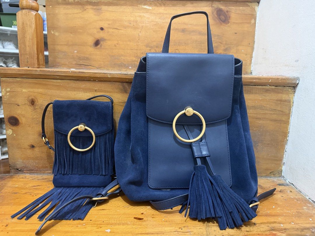 Tory Burch Bag Set (Category: Luxury Bags & Wallets) located in Baguio. Submitted by clemens031 (Listing ID 1438787175, Image 1). Description: - Navy blue backpack and crossbody bag set - Features a suede-like material - Gold-tone ring detail and tassel accents on both bags - Backpack: Flap closure and adjustable straps - Crossbody bag: Fringe detail.